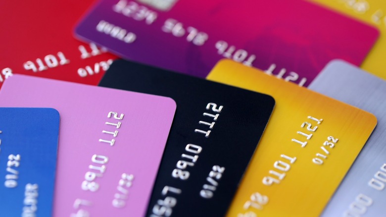 A stack of colorful credit cards laid out on a flat surface