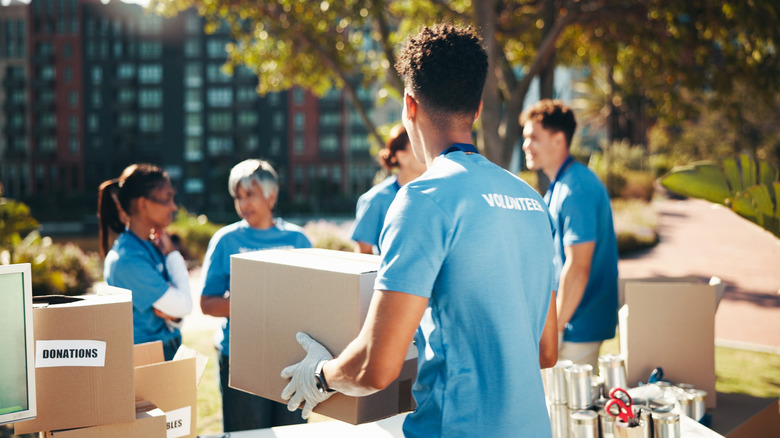 Volunteers moving boxes outdoors