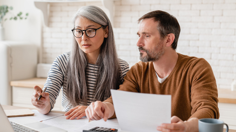 Mature middle-aged couple discussing investments