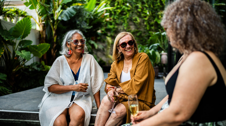 Older women sitting around a pool