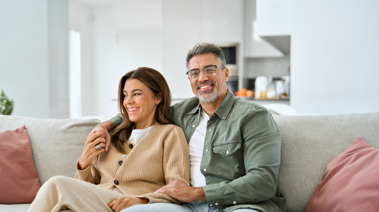 A happy mature couple sitting on a sofa