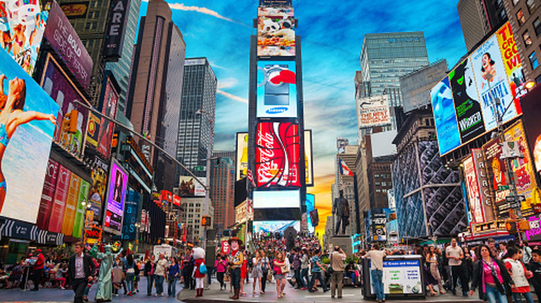 People exploring New York City's Times Square at dusk