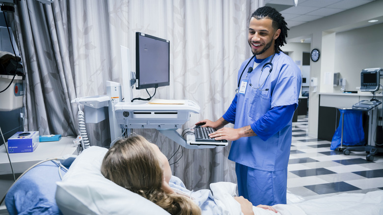 Medical professional speaking with patient while at computer