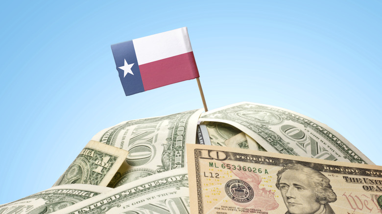 Texas flag on top of USD dollar bills