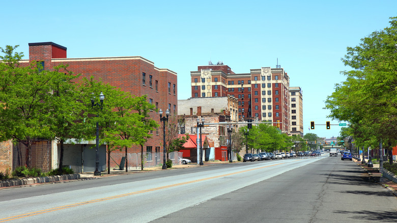 A street lined with brick buildings and trees in Gary, Indiana