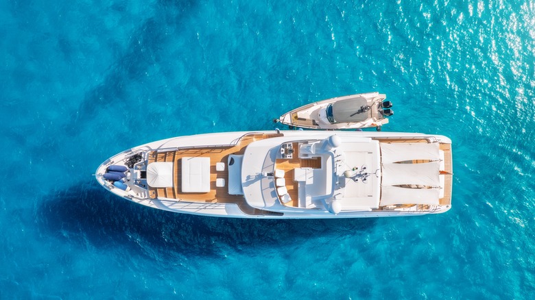 Aerial view of beautiful luxury yacht and boat in blue sea in summer.