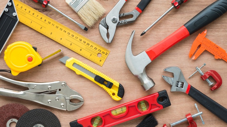 an assortment of tools arranged on a wooden table