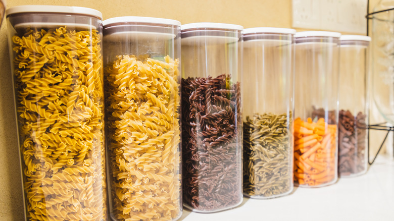 Six tightly sealed containers of cereals of different types