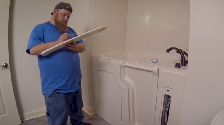 Man installing a walk-in bathtub