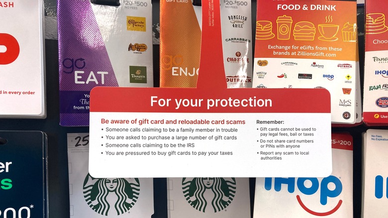 Gift card rack with warnings about scams