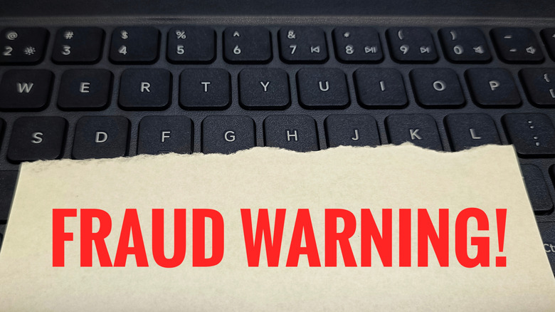 fraud warning note over keyboard