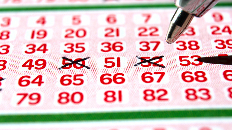 Pen picking numbers for a lottery ticket