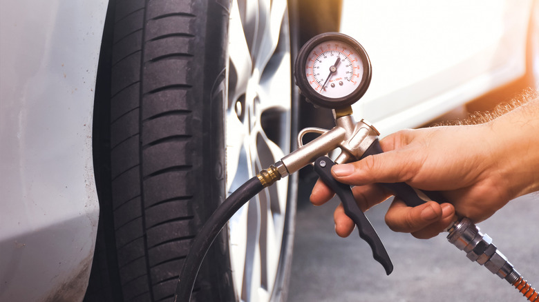 Mechanic filling car tire.