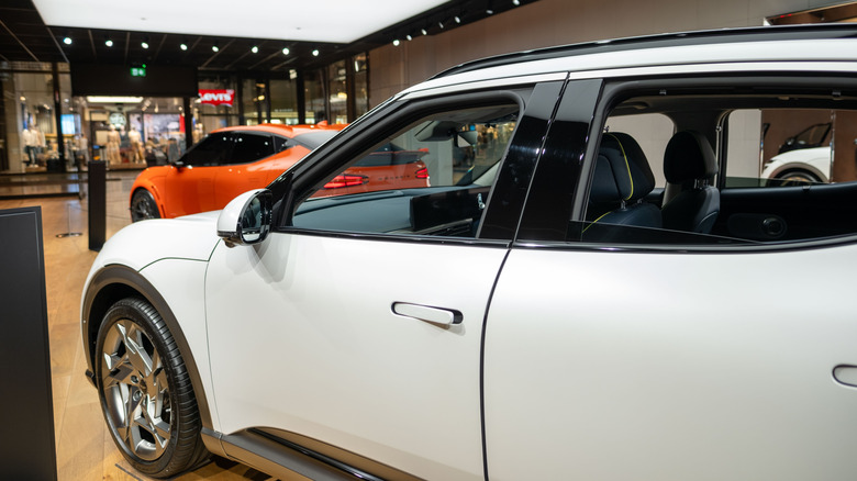 white and orange 2024 Genesis GV60s in showroom
