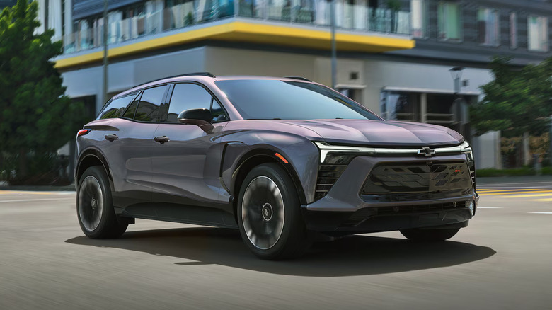bluish 2025 Chevrolet Blazer EV in front of building with a yellow overhang