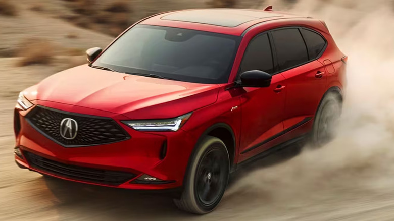 red 2024 Acura MDX stirring up dust on desert-like road