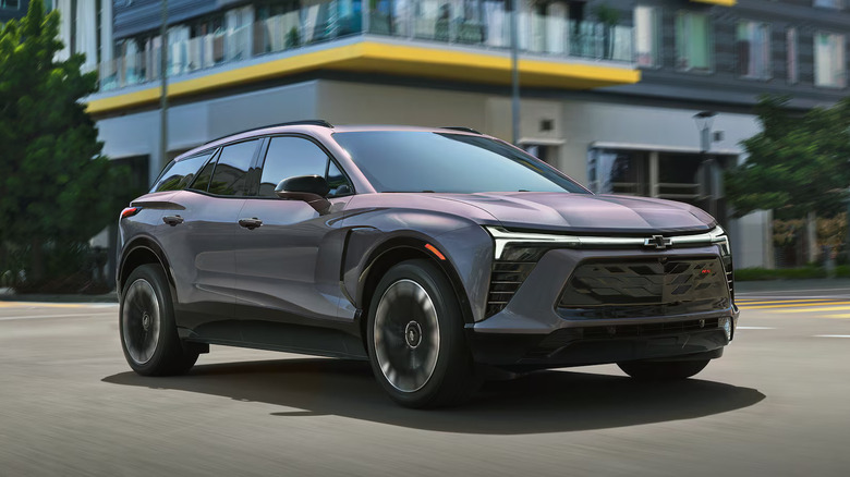 bluish 2025 Chevrolet Blazer EV in front of building with a yellow overhang