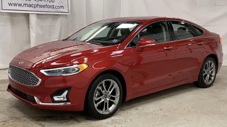 A black Ford Fusion parked in a driveway.