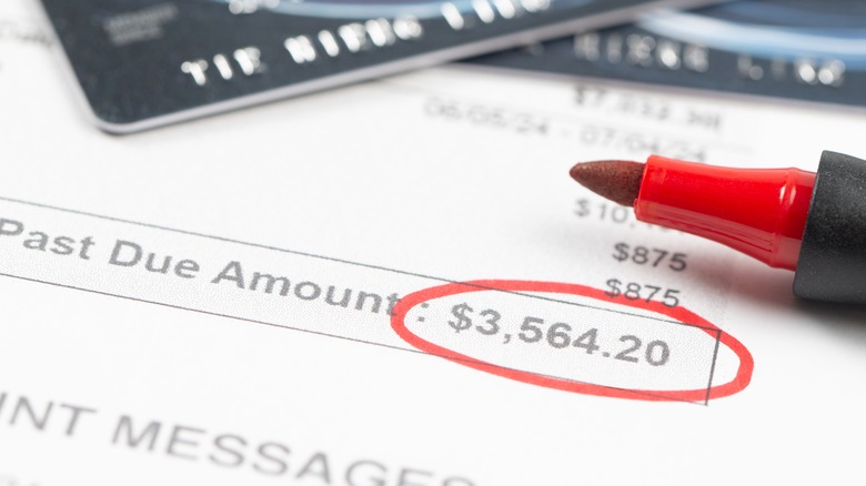 A credit card statement up close with past due amount circled