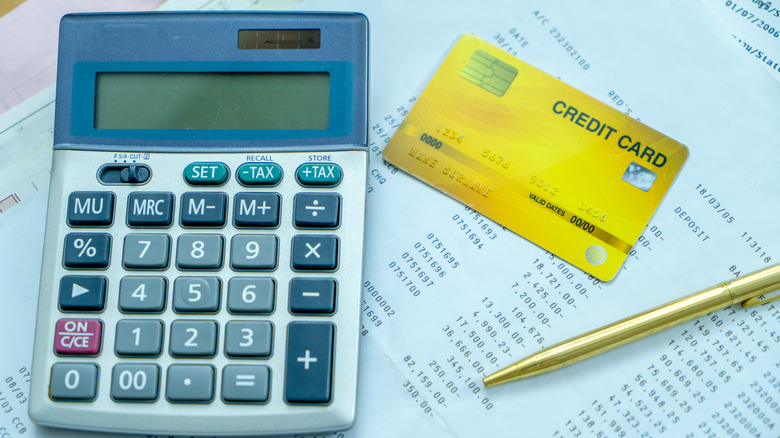 credit card and calculator on a statement document