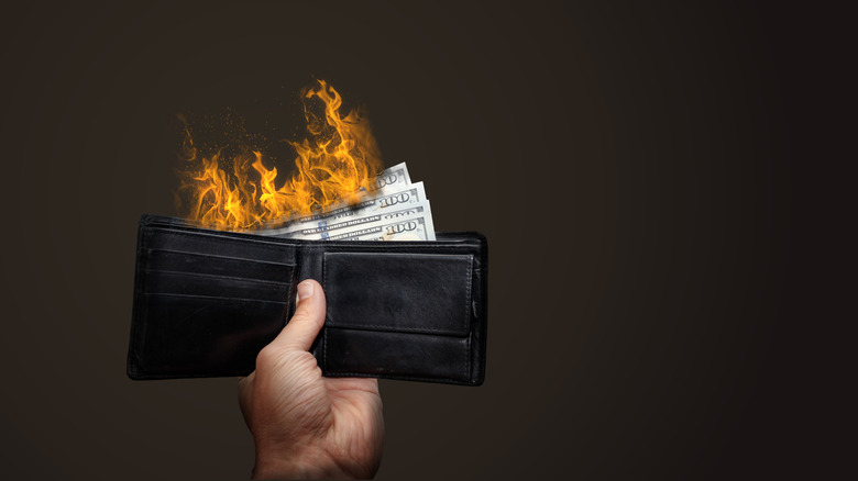 money in a wallet on fire