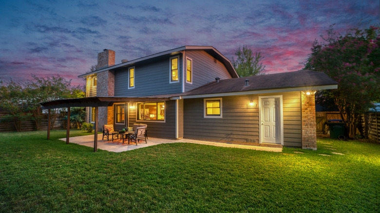 a home in the evening with outdoor lights on