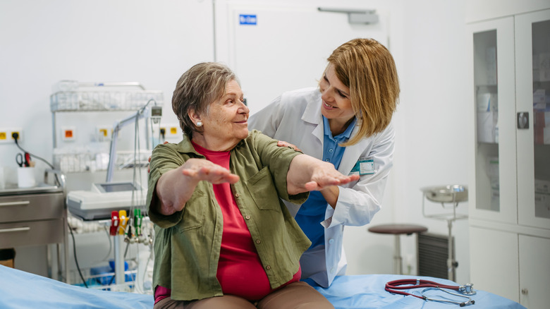 A doctor giving a senior woman a routine physical.