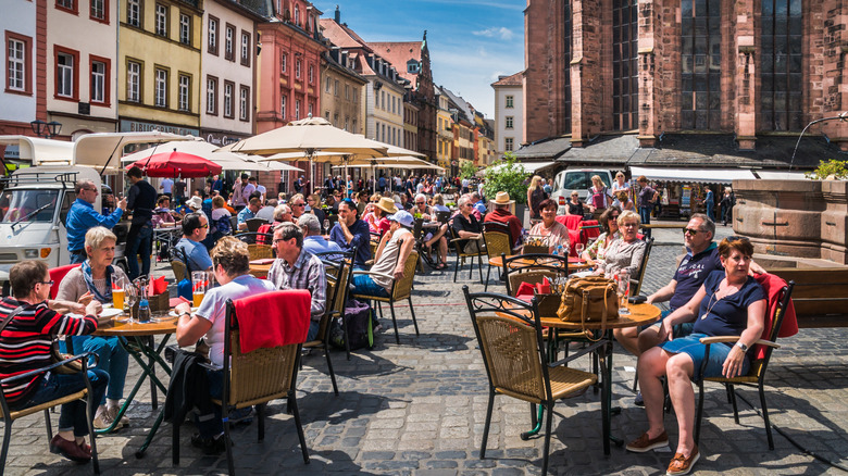 Groups of people sitting at tables at an outdoor restaurant
