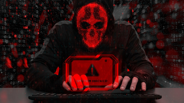 Digitized image of a masked hacker using a keyboard