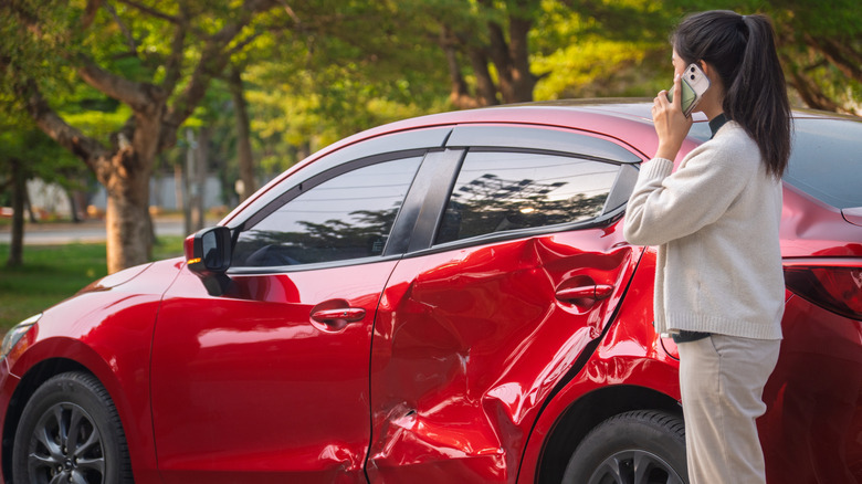 Driver making a call after an accident.